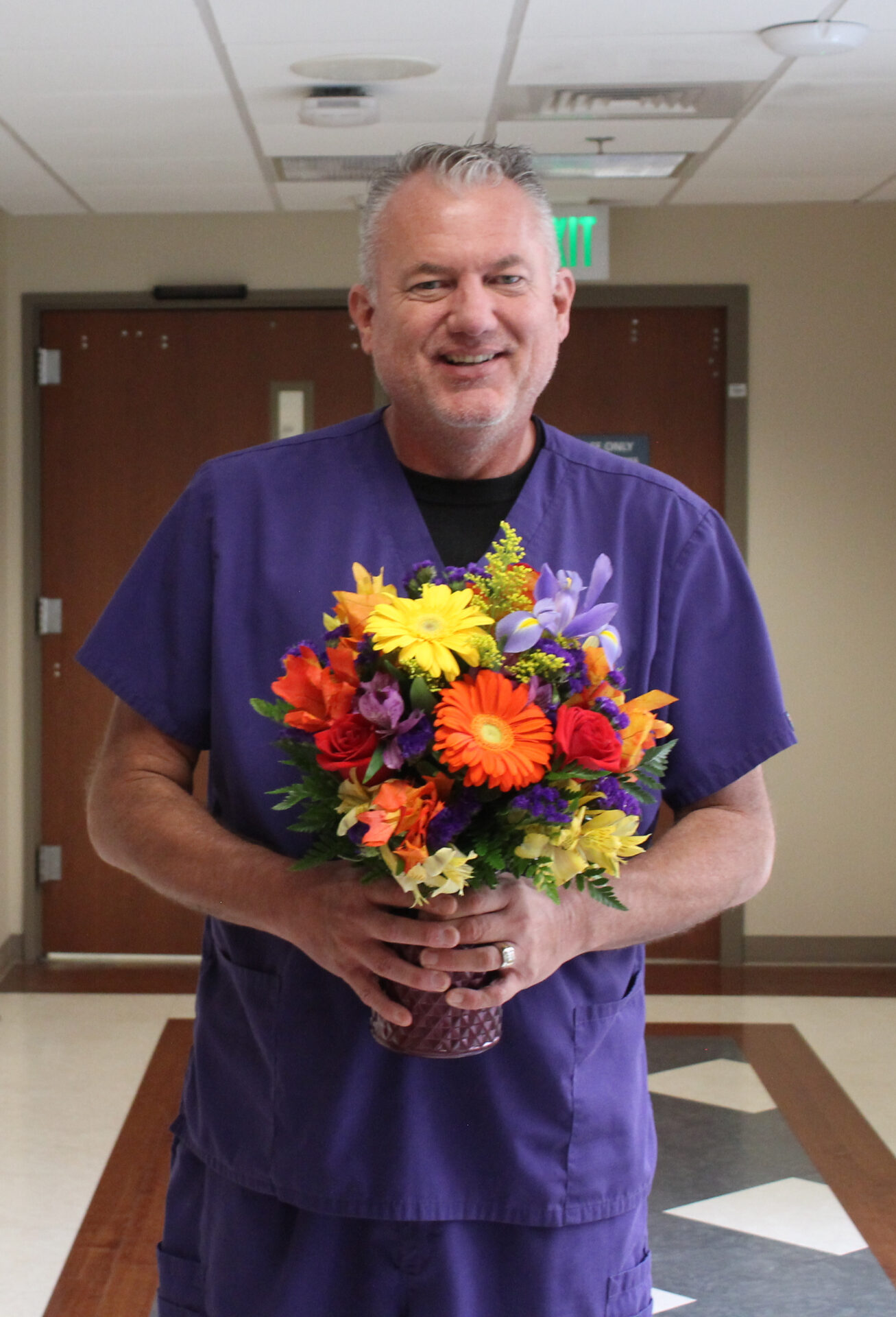 Scott is pictured with his BEE flower arrangement.