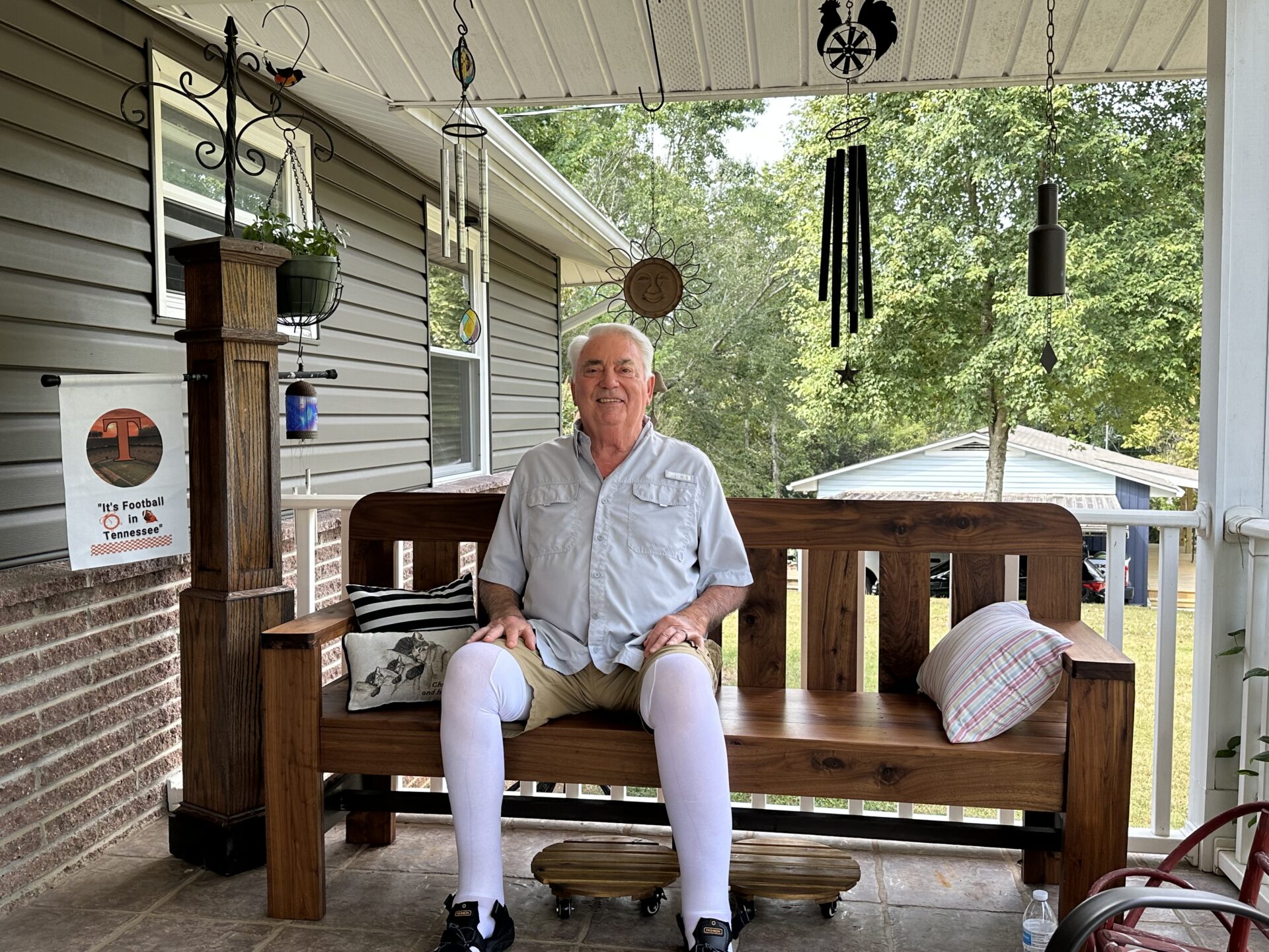 Jay Ambrister relaxes on the porch he built years ago at the family’s home.