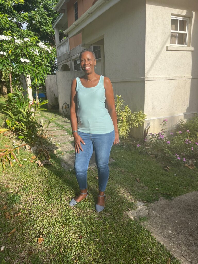 Laurie Blackman, breast cancer survivor, poses outside of her home in Barbados. 