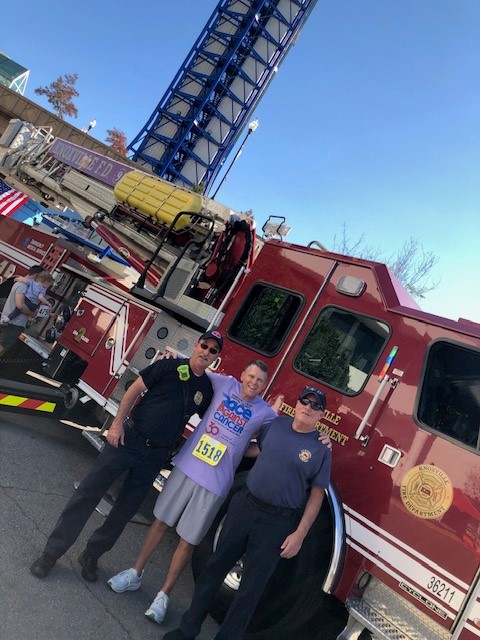 Nick Parker smiles with first responders at Race Against Cancer.