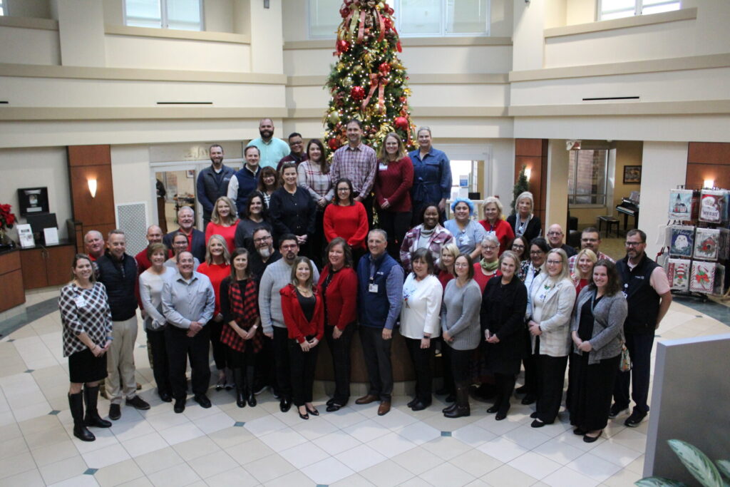 Parkwest leadership team in front of Christmas tree.