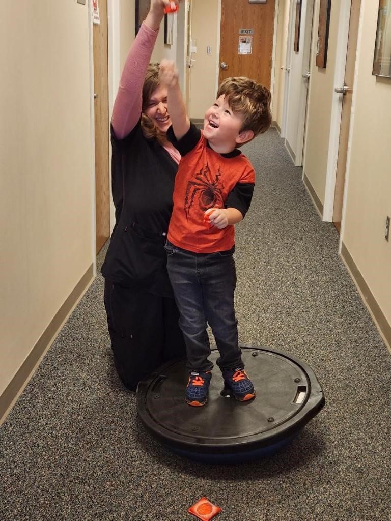 Lauren Wilson, PT, works with Jensen Rains on balance and mobilization.