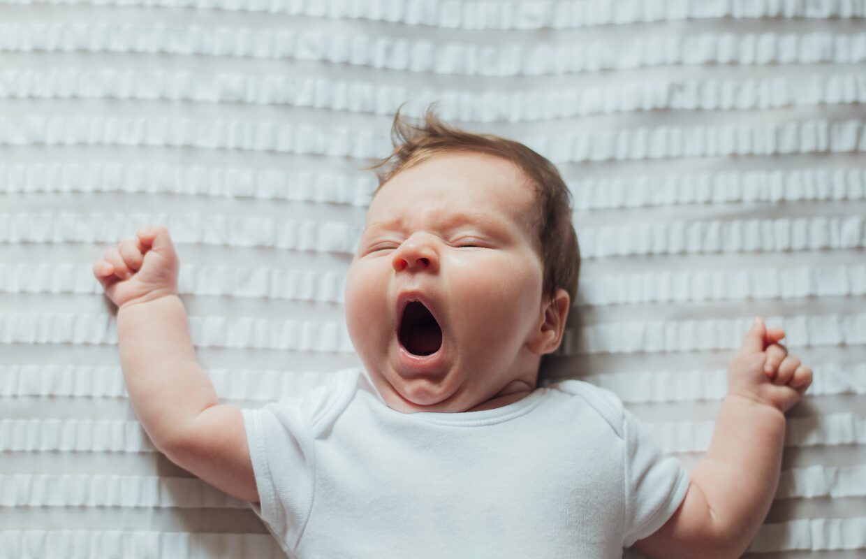 Infant on back stretching