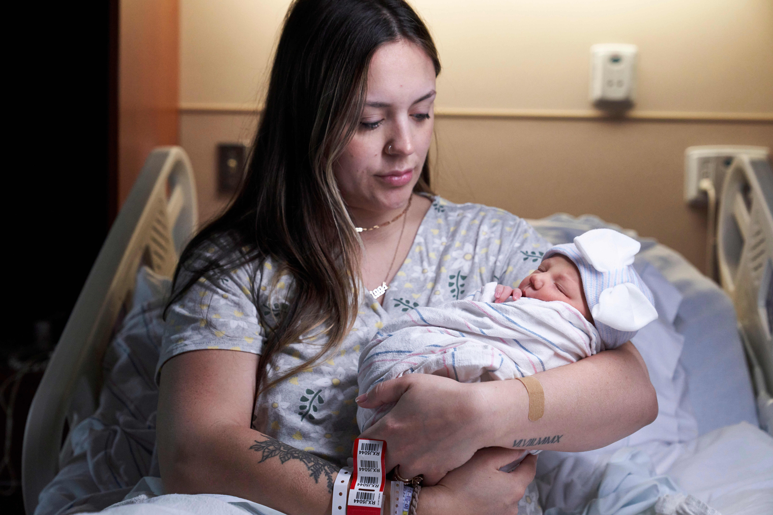 woman holding newborn baby after delivering