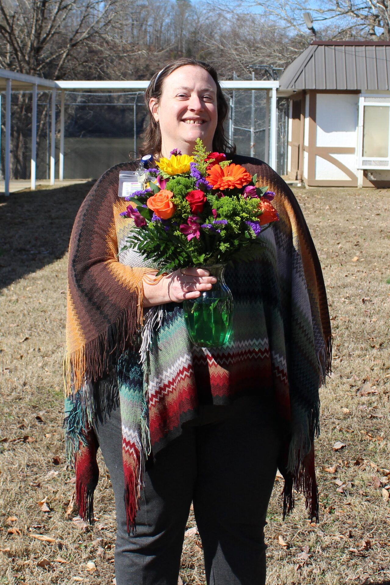 Robin is pictured here outside holding her BEE flower arrangement.