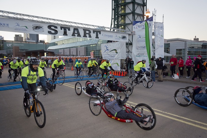 Hand cyclists taking off from the start line of the Covenant Health Knoxville Marathon