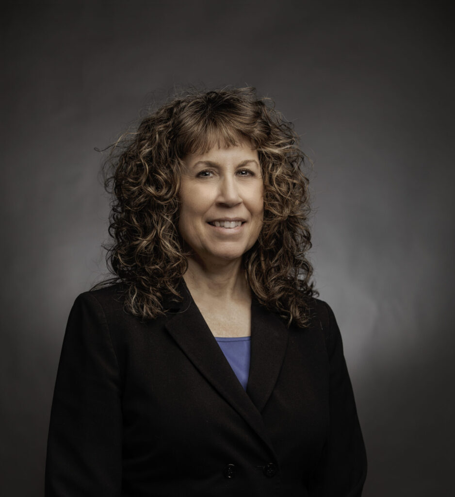 Headshot of Jacquelyn Alt wearing black suit.