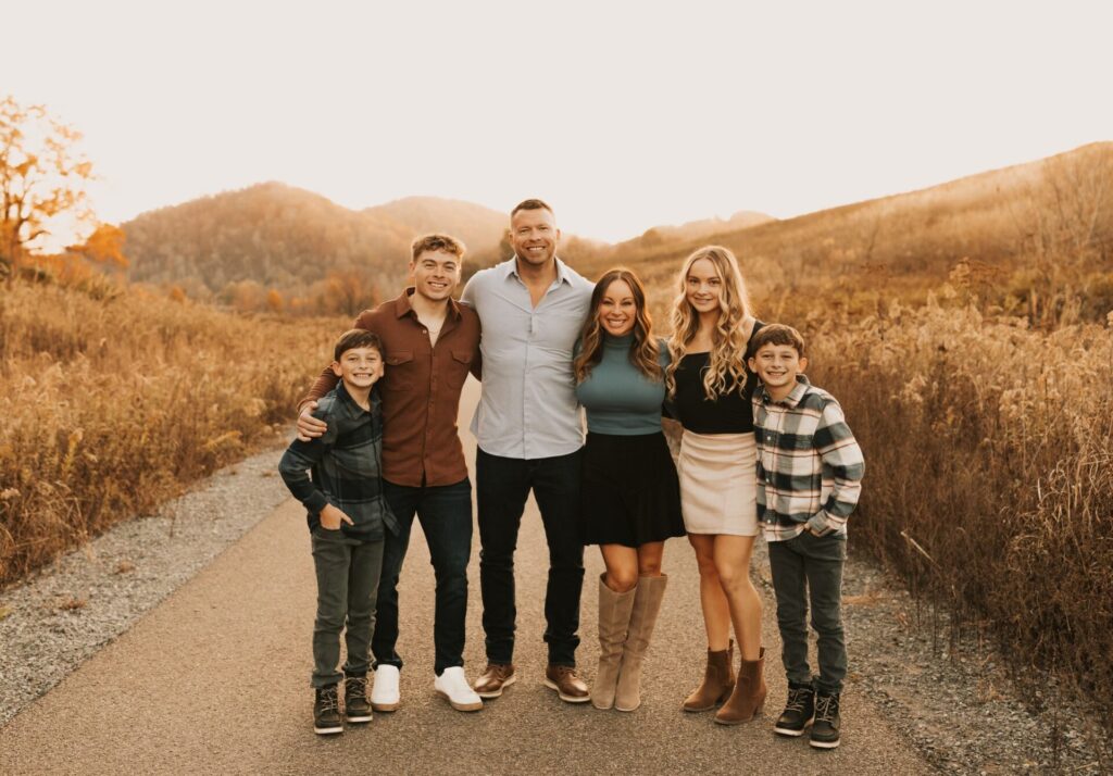 Aaron Burns smiles with his family