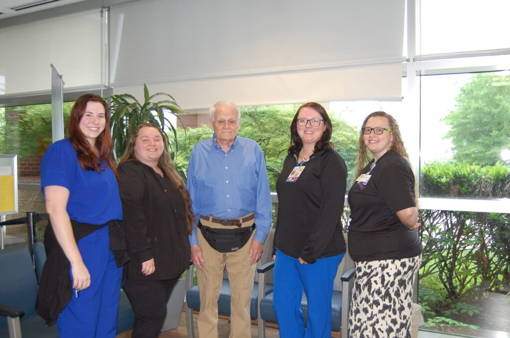 ER team members with patient in lobby.