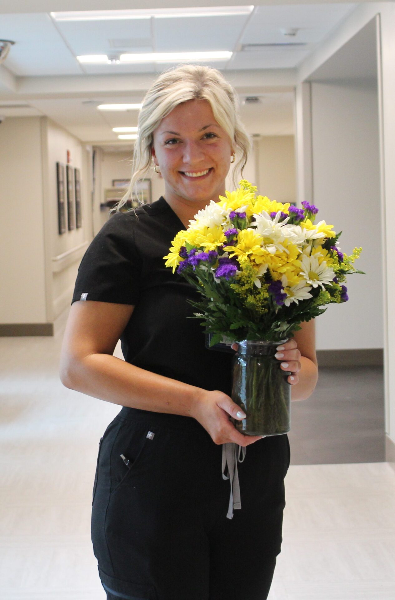 Brianna pictured holding her beautiful DAISY bouquet.