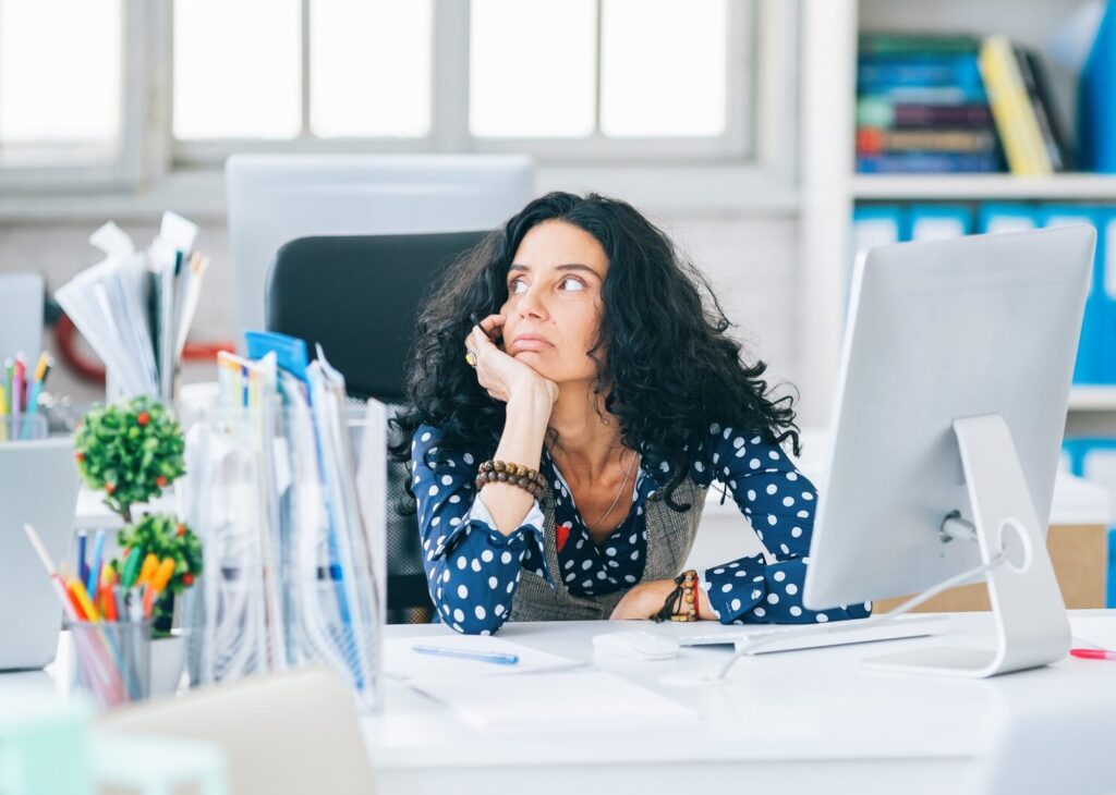 woman-at-desk-gazing-into-space