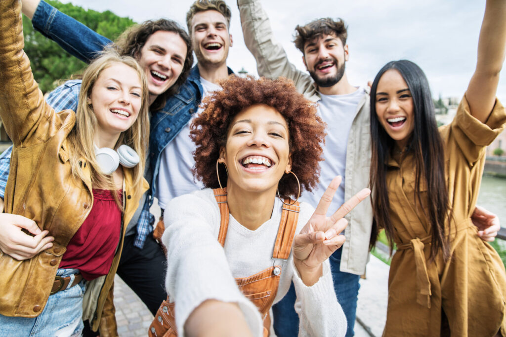 Group of young men and women smiling at camera