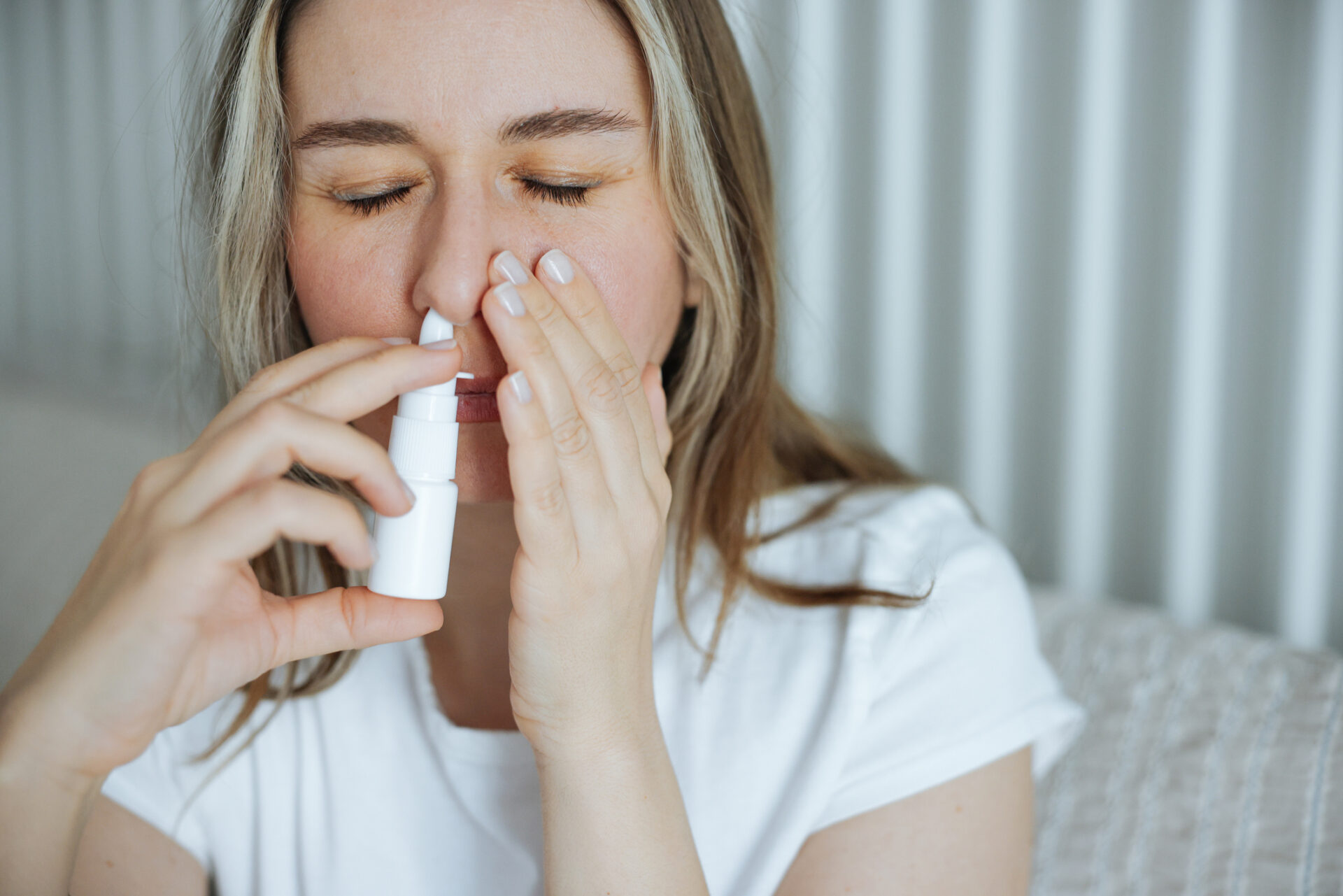 Woman using nasal spray