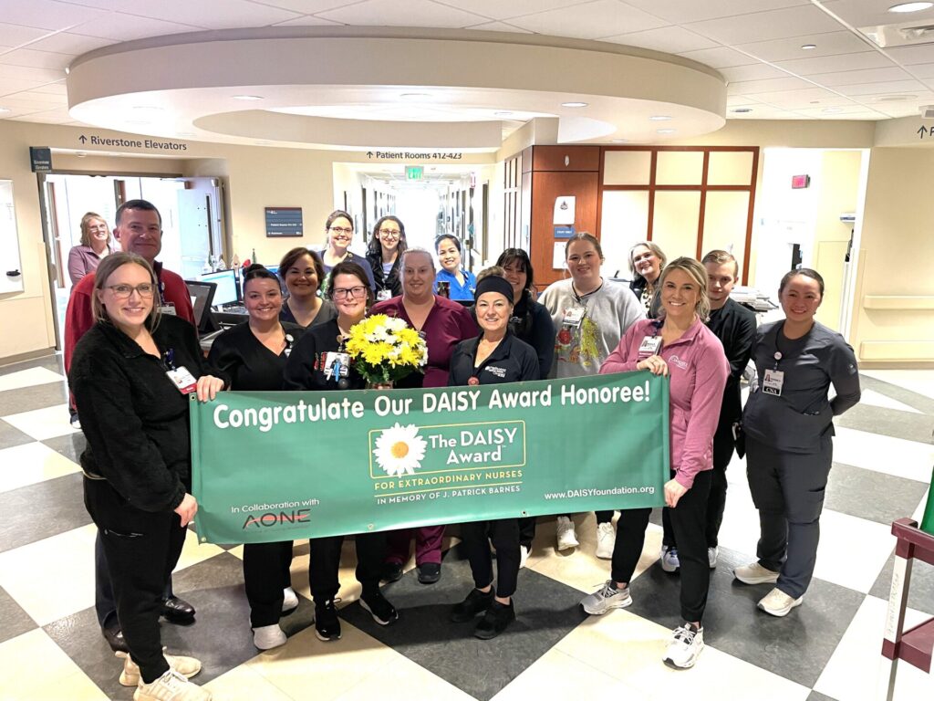 Group with winner, and DAISY Award banner