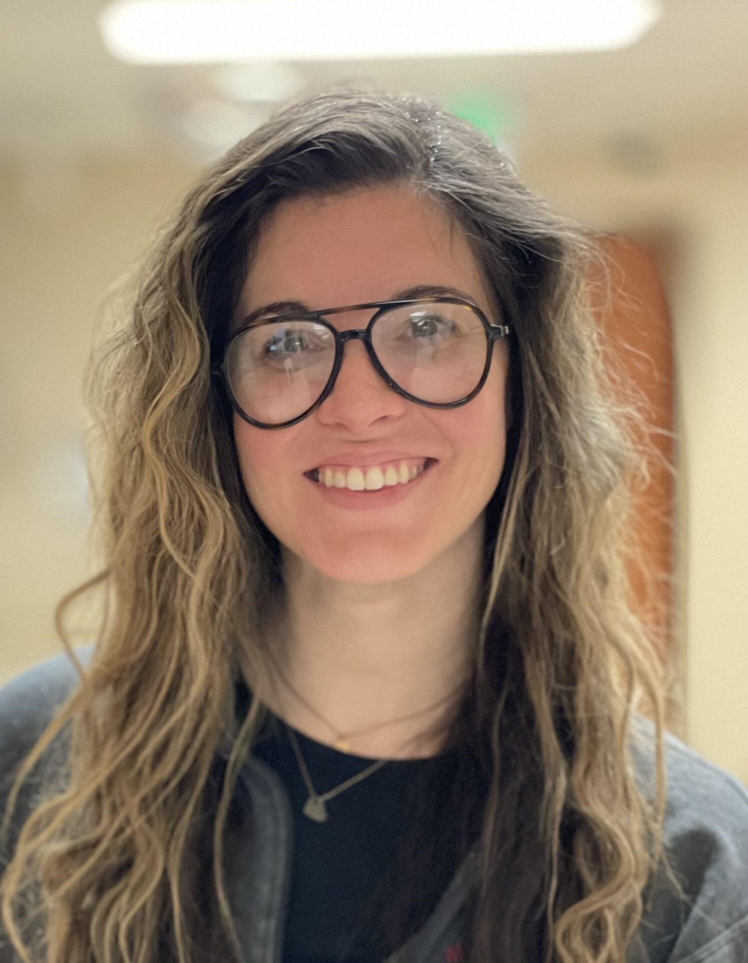 Close up Bridget Frazier smiling, wearing glasses.