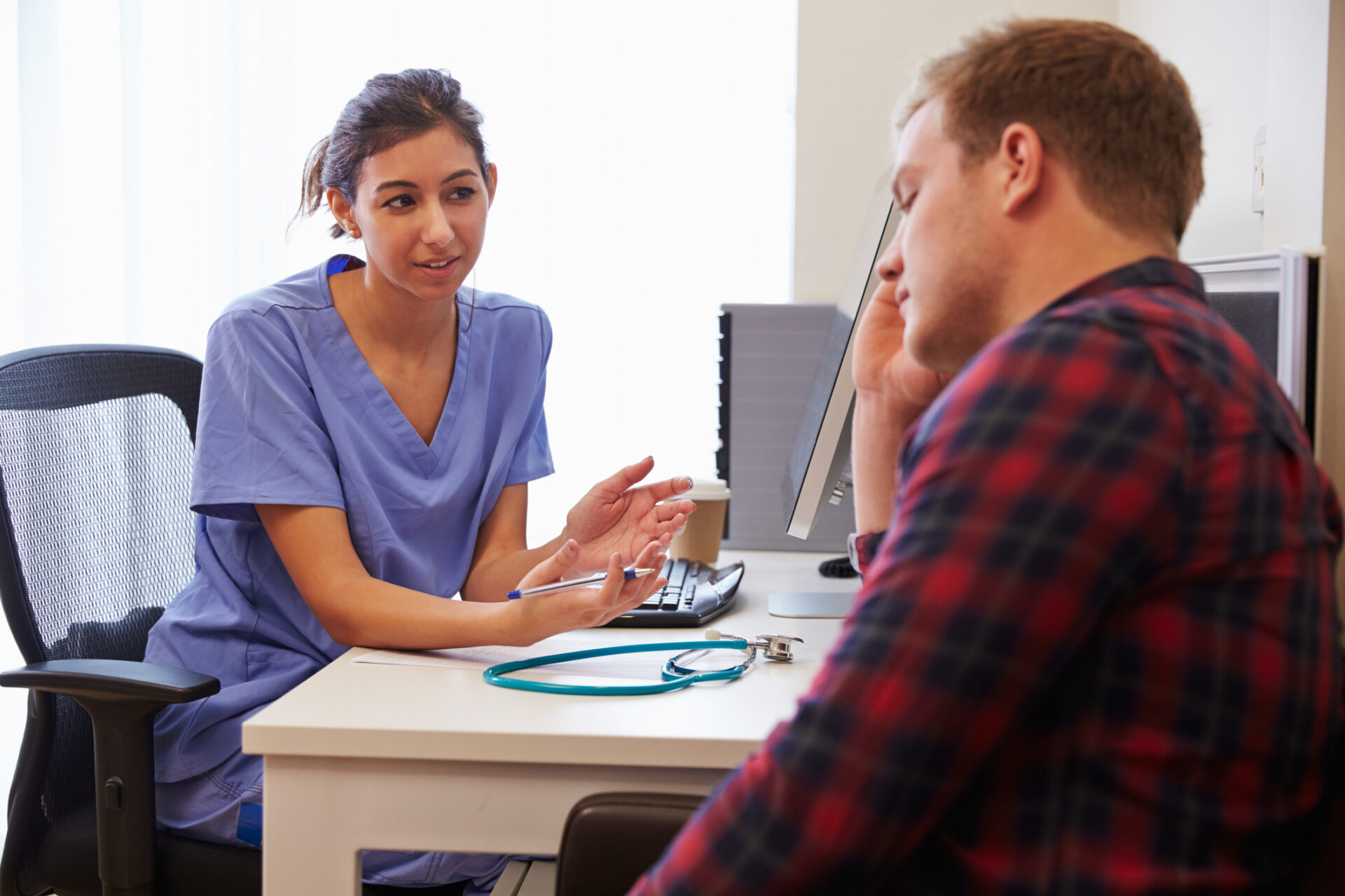 young female student nurse smiling with other students blurred in background