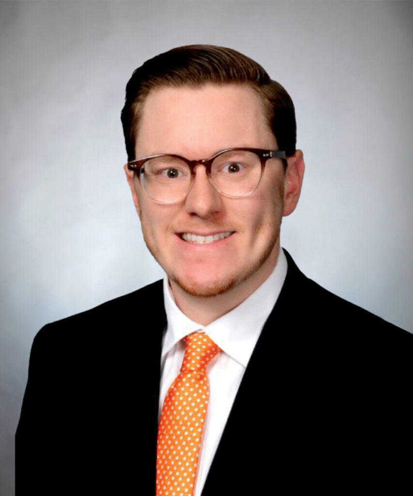 Headshot of Dr. Zachary McCormick smiling, dressed in suit and tie.