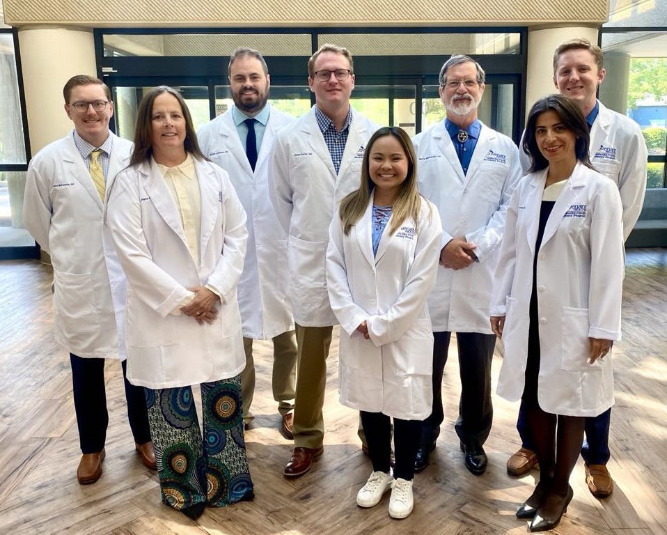 Group photo of the Methodist Family Medicine Residency Class of 2028, including five men and three women wearing white medical coats while standing together indoors
