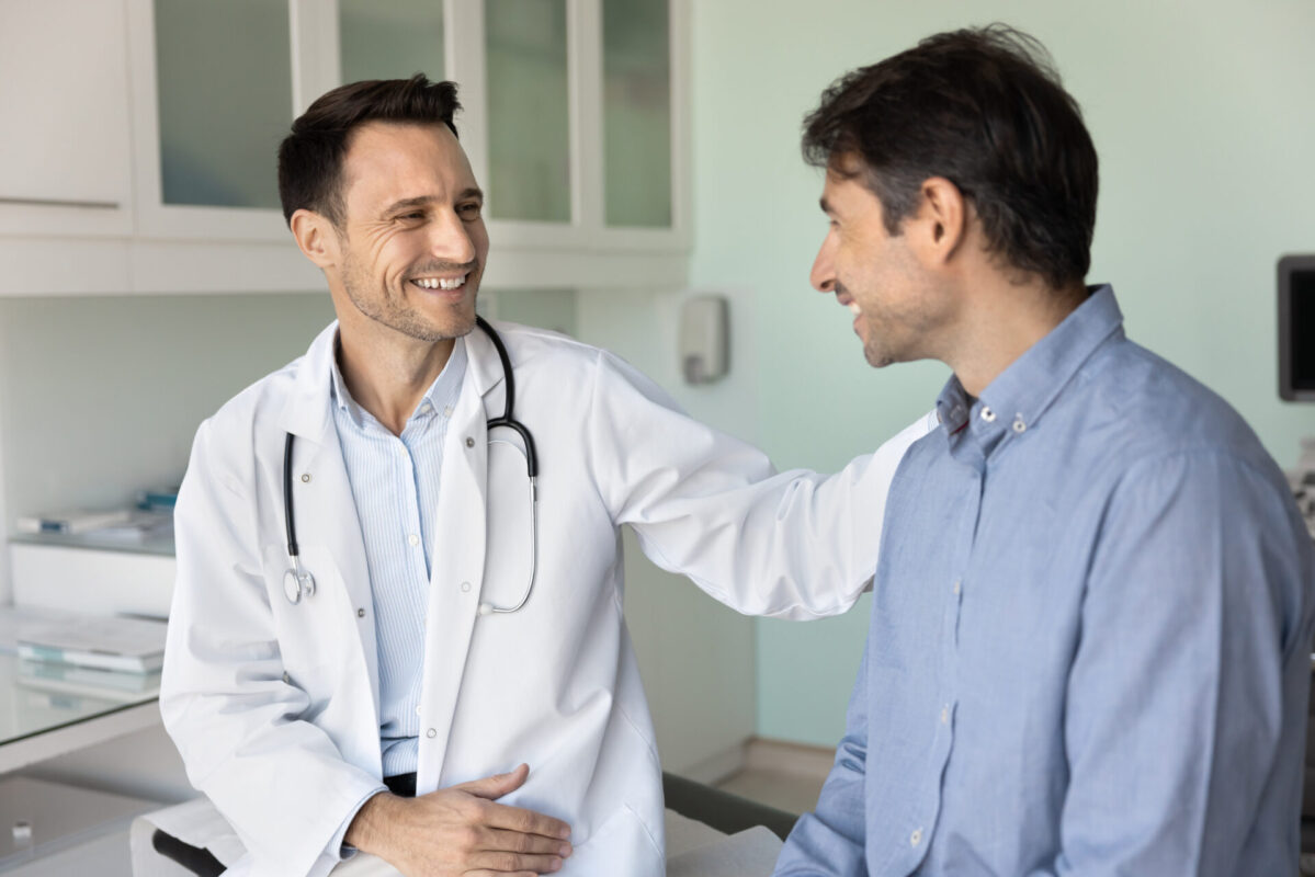 Limb Salvage Web Image 2 Doctor in lab coat talking with patient.