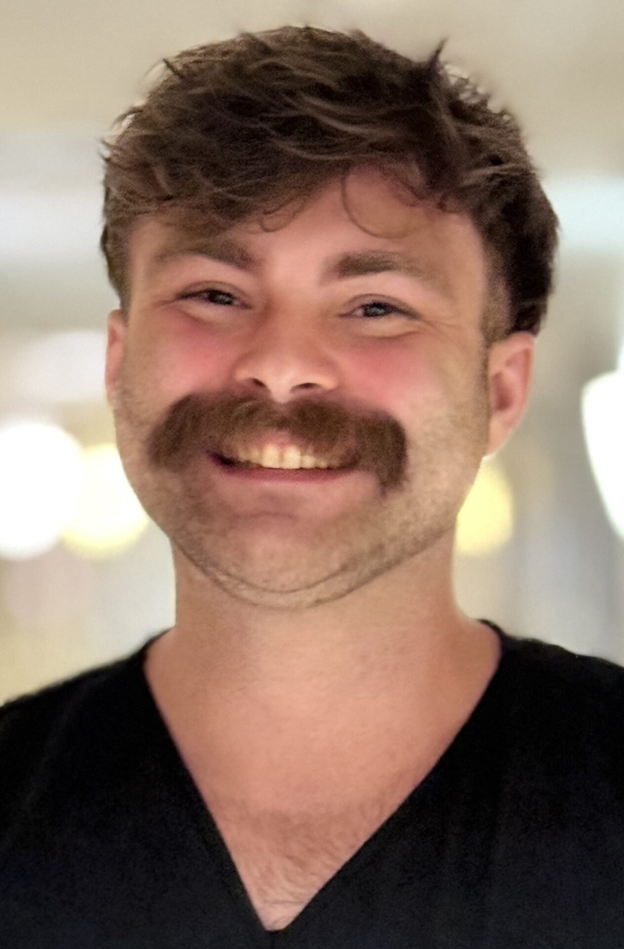 Smiling man with mustache.