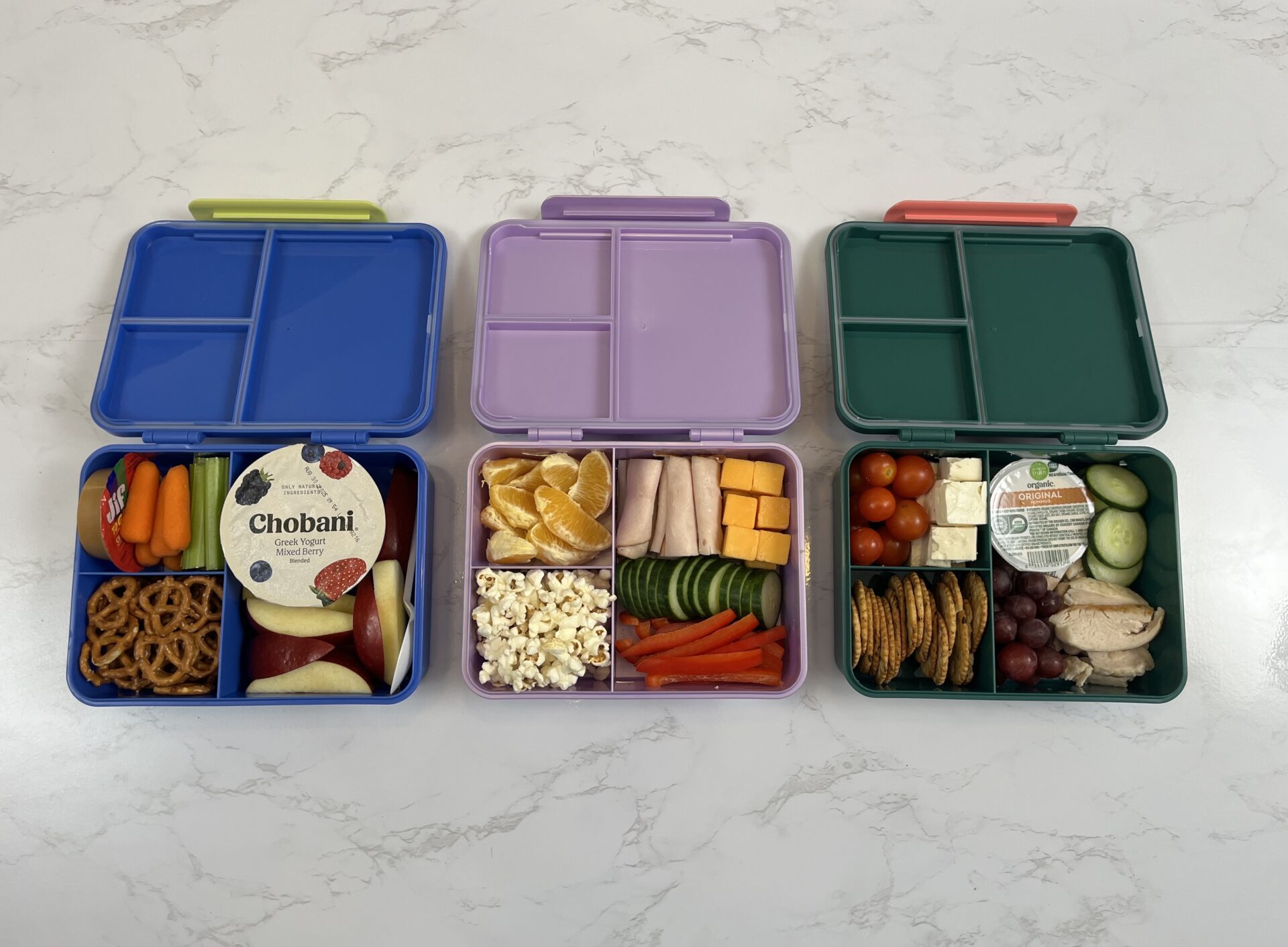 Three bento boxes full of well-rounded healthy meals