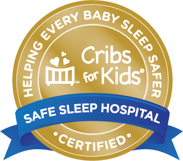 Gold seal badge with Cribs for Kids logo in the center, surrounded by the text Helping every baby sleep safer. A blue ribbon label reads Safe Sleep Hospital Certified.