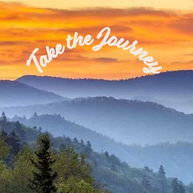 A colorful sunrise or sunset sky over misty, tree-covered mountains with the words Take the Journey written in white script across the top, inspired by the spirit of discovery at Covenant Health University.