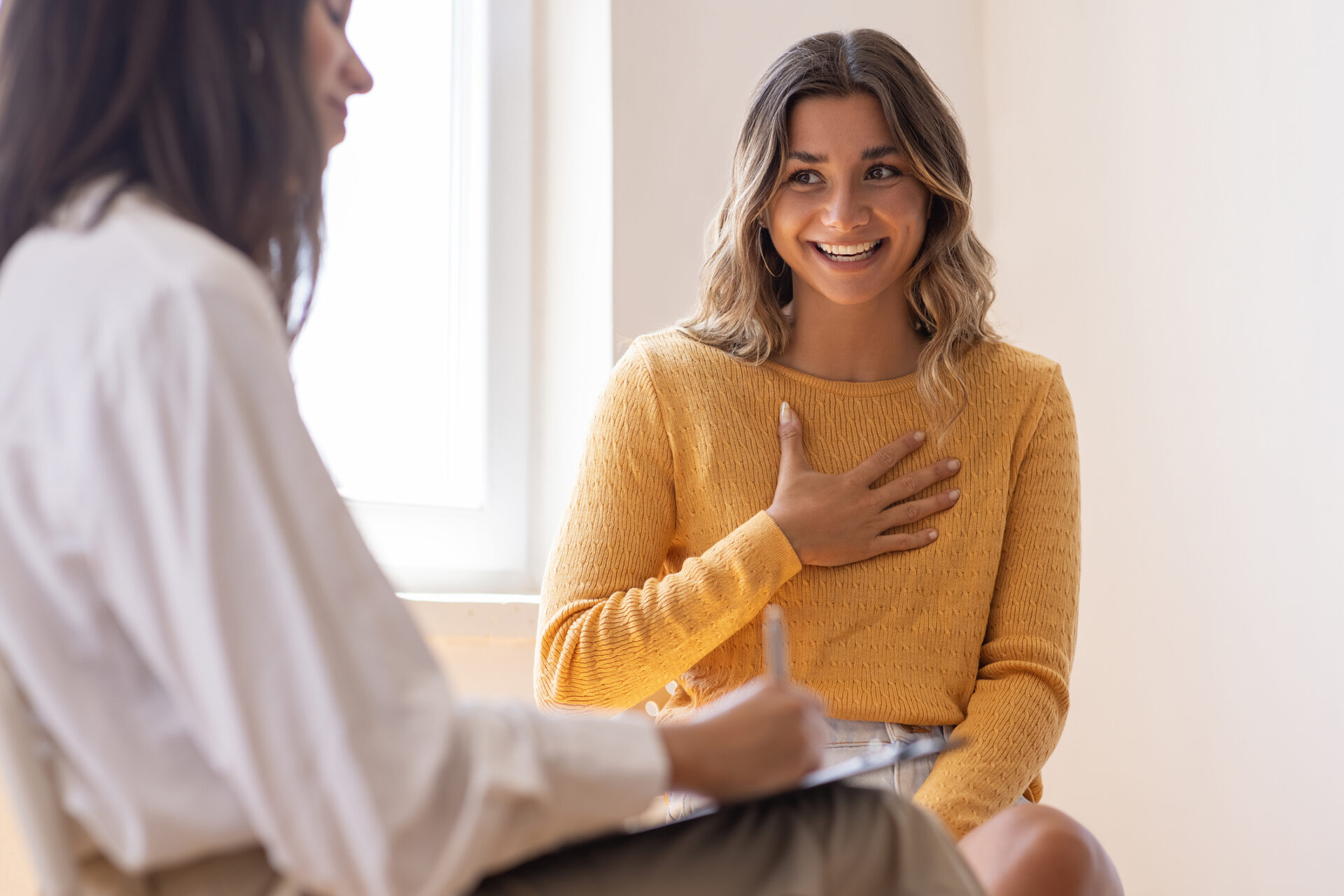 Young adult female talking to adult female healthcare provider.