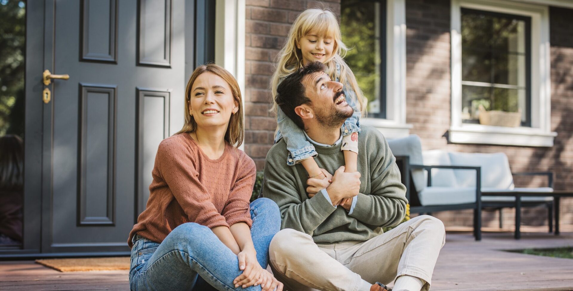 A man and woman sit on the steps of a house, enjoying a quiet moment together, reflecting the warmth and support of Covenant Health Community Care Sevierville.