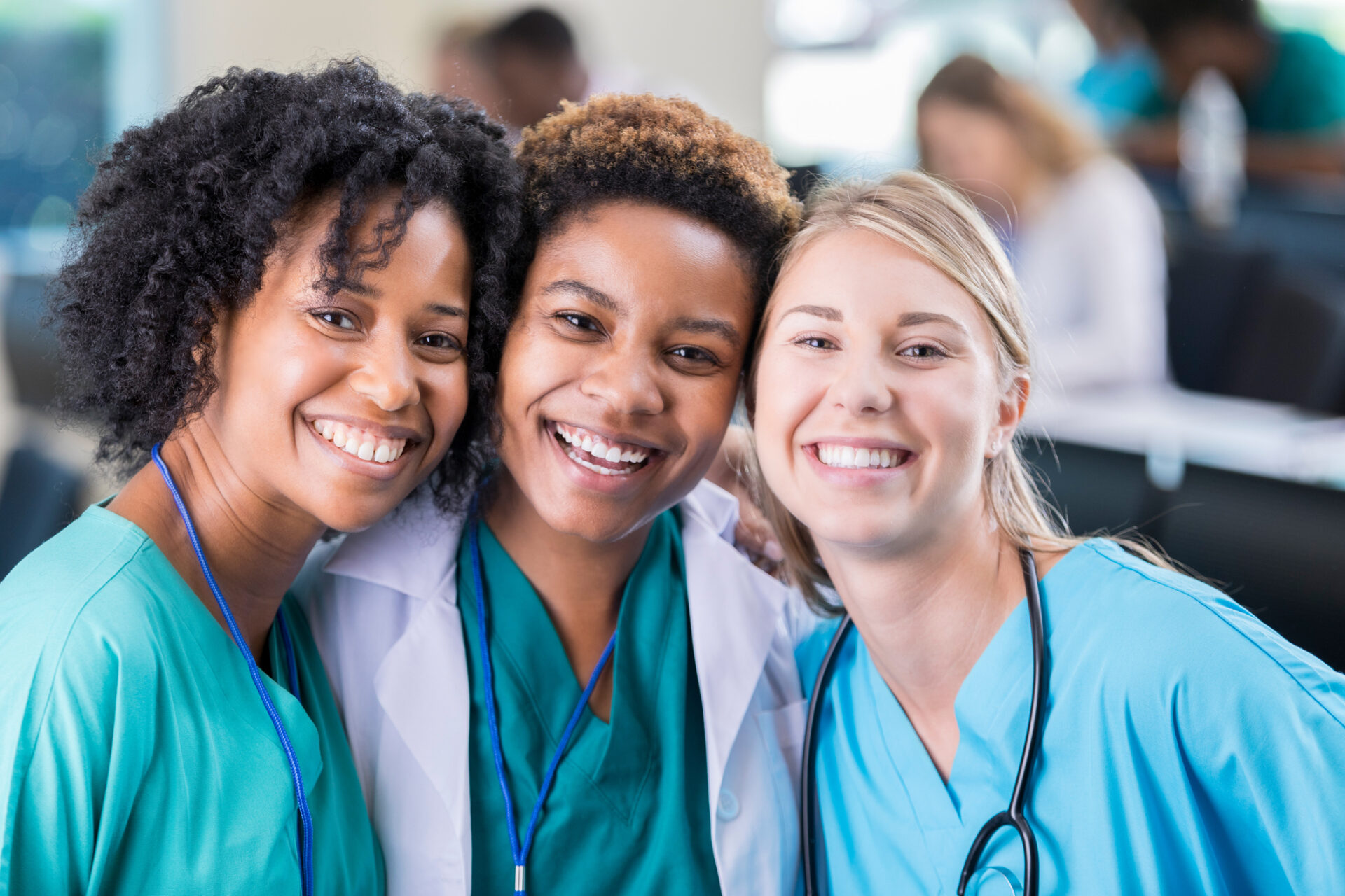 Three smiling female health care workers.